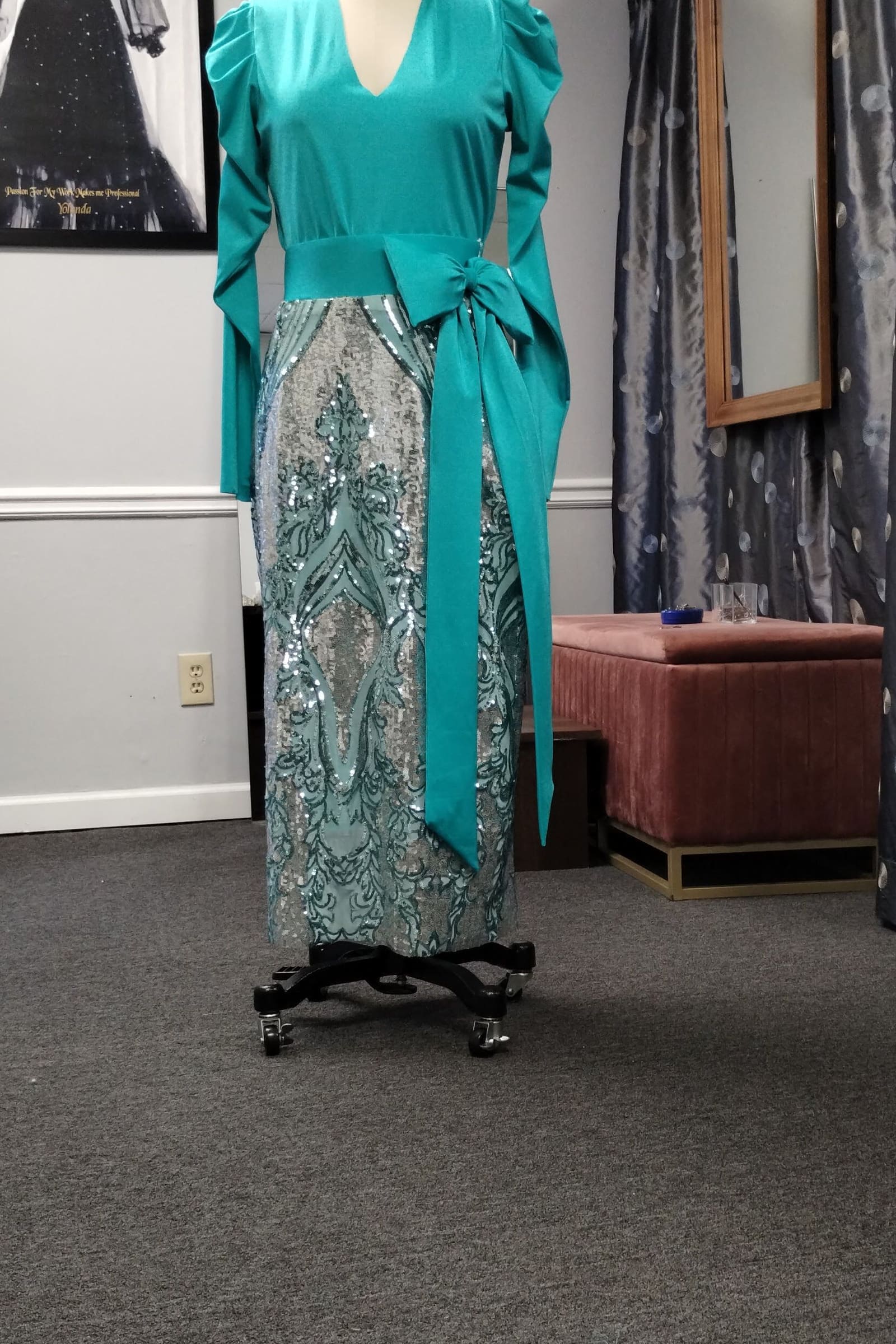 Teal long-sleeve top with a sequined column skirt on a dress form